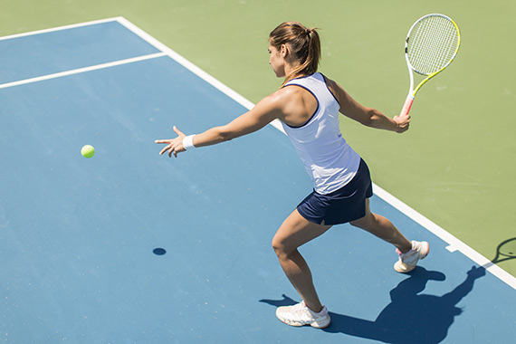 Woman serving tennis